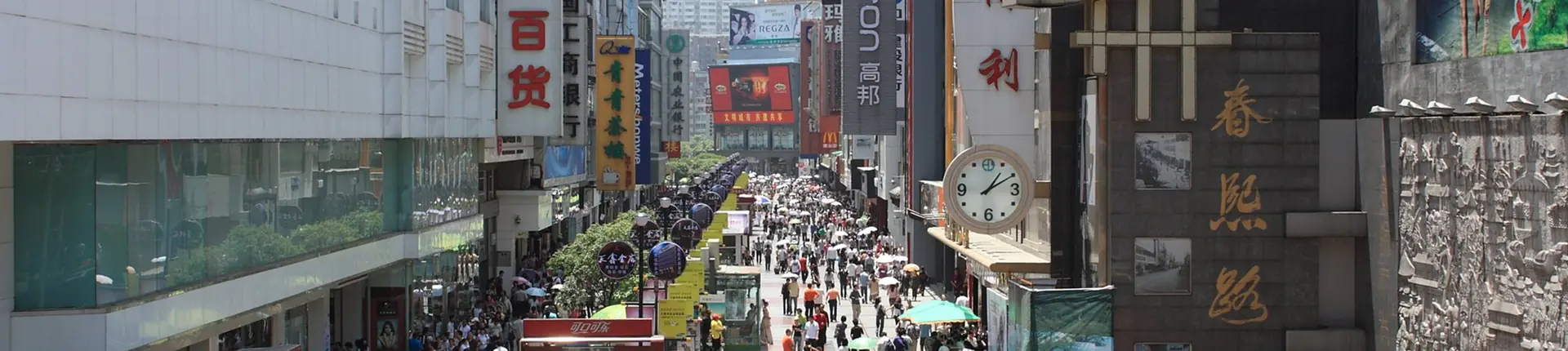 Shoppers and colorful signs along the busy pedestrian street of Chunxi Road, Chengdu