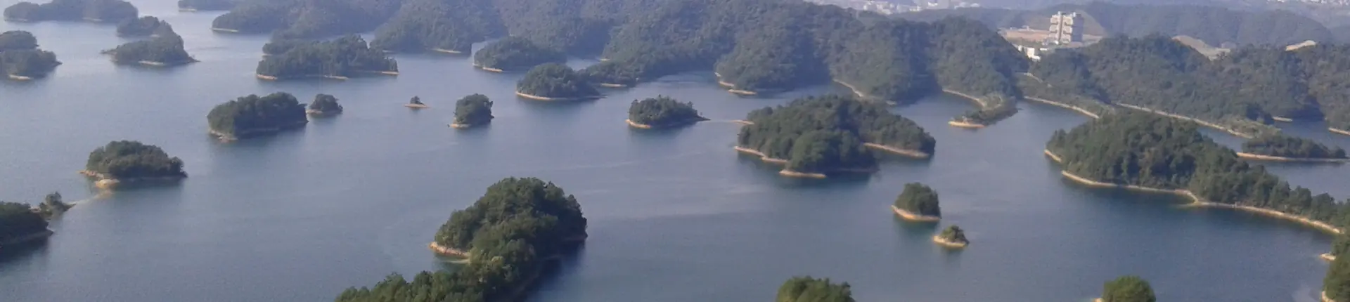 Wooded islands scattered across the blue waters of Qiandao Lake near Hangzhou