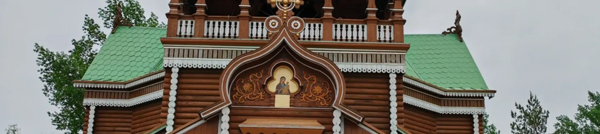 Red timber church facade and green roof at Volga Manor near Harbin