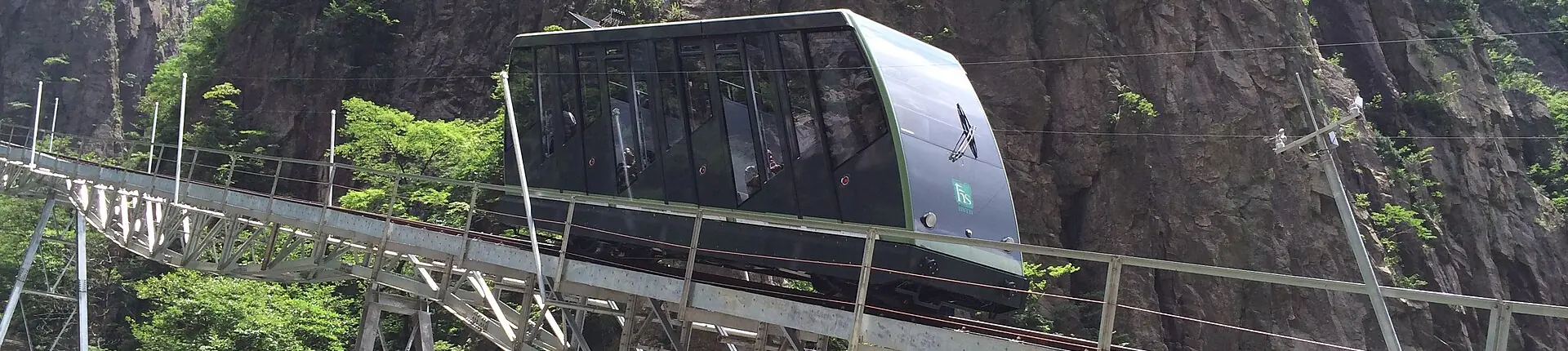 Cable car cabin beside a steep rock face on Huangshan in Anhui