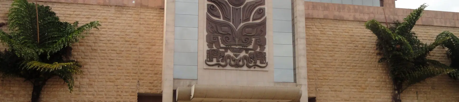 Carved relief panel between stone columns at a museum entrance