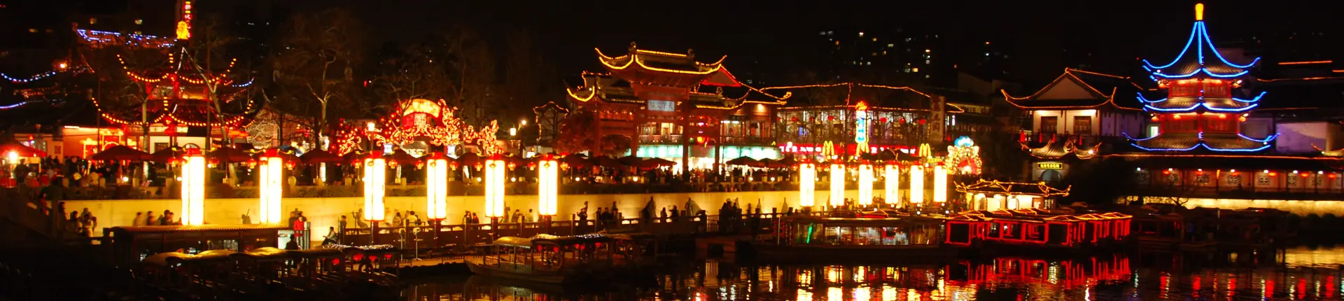 Traditional riverside buildings illuminated above the Qinhuai River at night in Nanjing