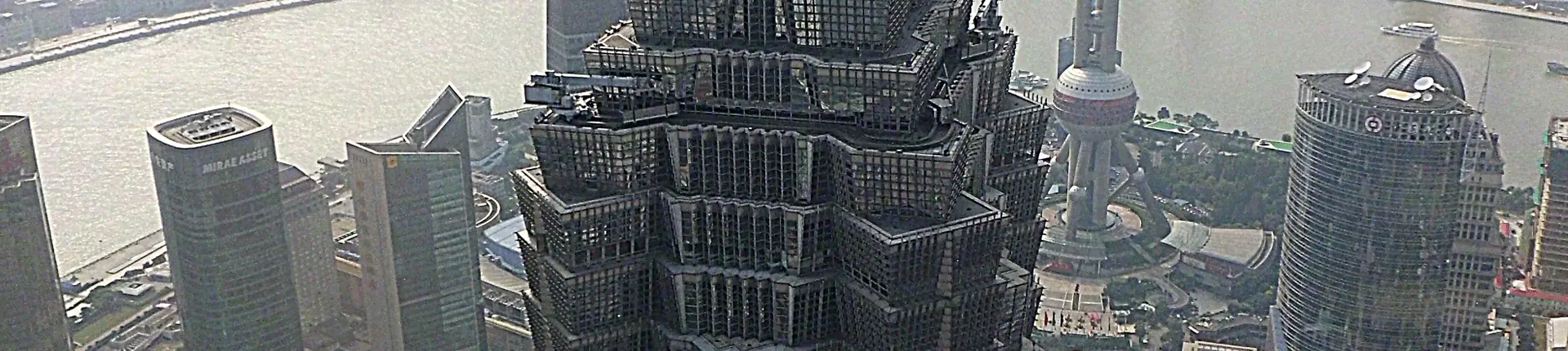 Stepped upper floors of Jinmao Tower seen among neighboring skyscrapers in Shanghai