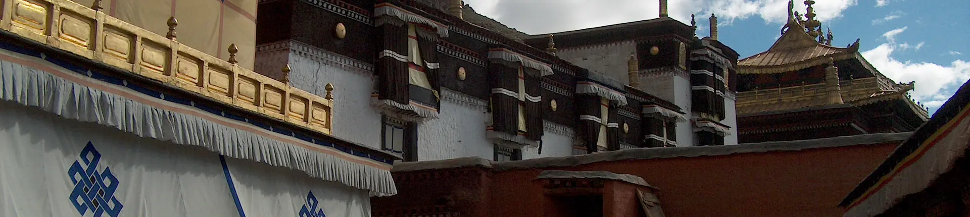 Painted monastery walls, gold trim and balconies at Tashilunpo Monastery, Tibet