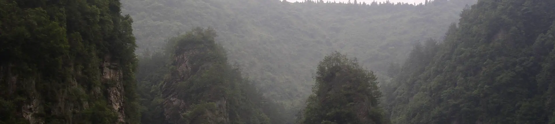 Misty wooded valley and steep cliffs around Baofeng Lake in Zhangjiajie