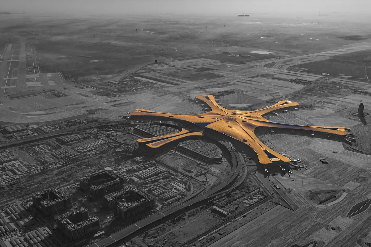 Aerial airport photograph with a golden star-shaped terminal highlighted in color