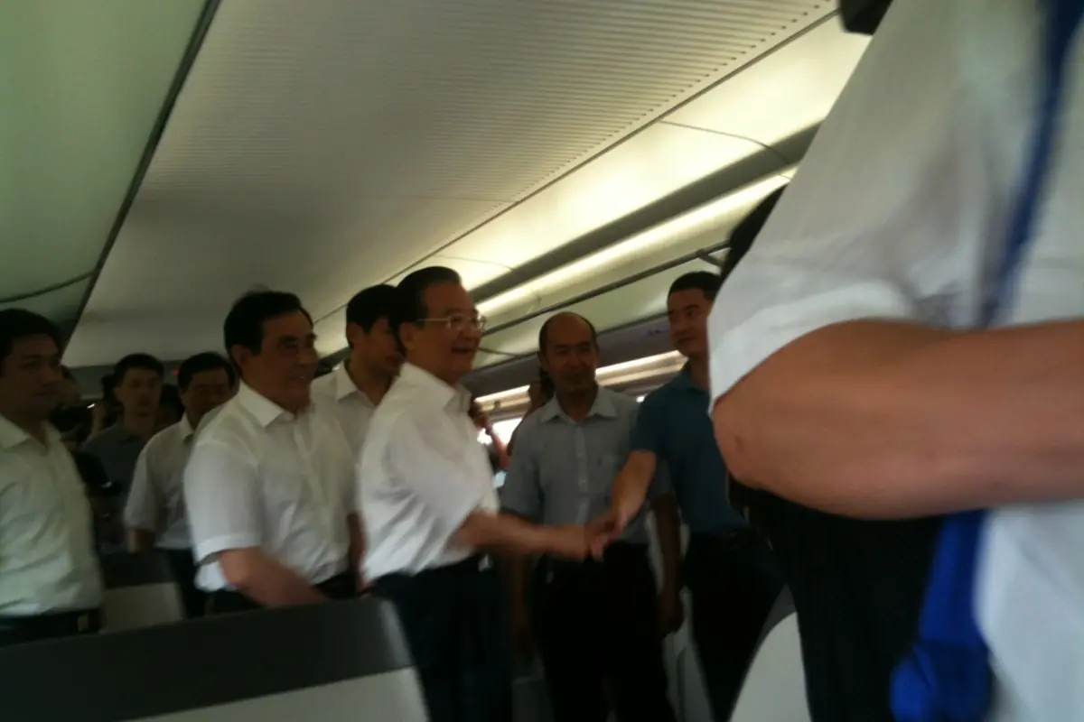 Passengers standing close together inside a train carriage