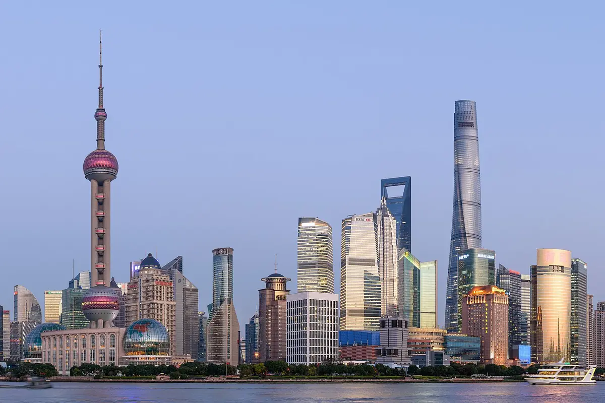 Shanghai's Pudong towers and Oriental Pearl Tower beside the Huangpu River at dusk