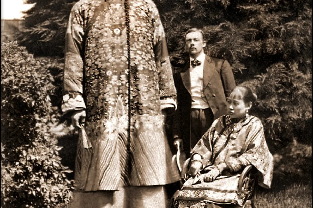 Historic sepia portrait of people in traditional clothing posing outdoors