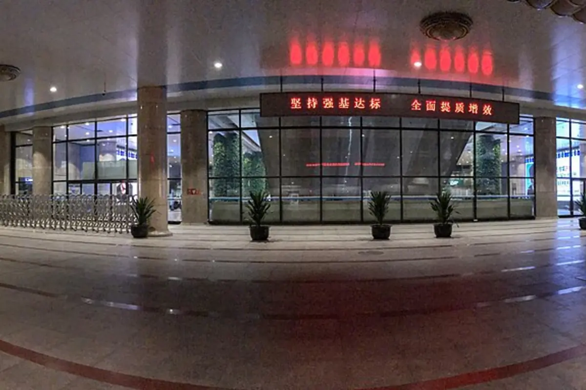 Glass-fronted restaurant entrance with illuminated red Chinese signage at night
