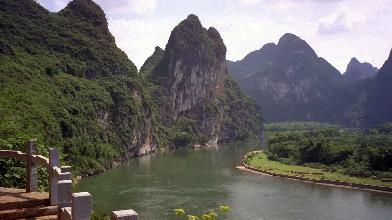Karst peaks above a river bend and green fields near Guilin, Guangxi