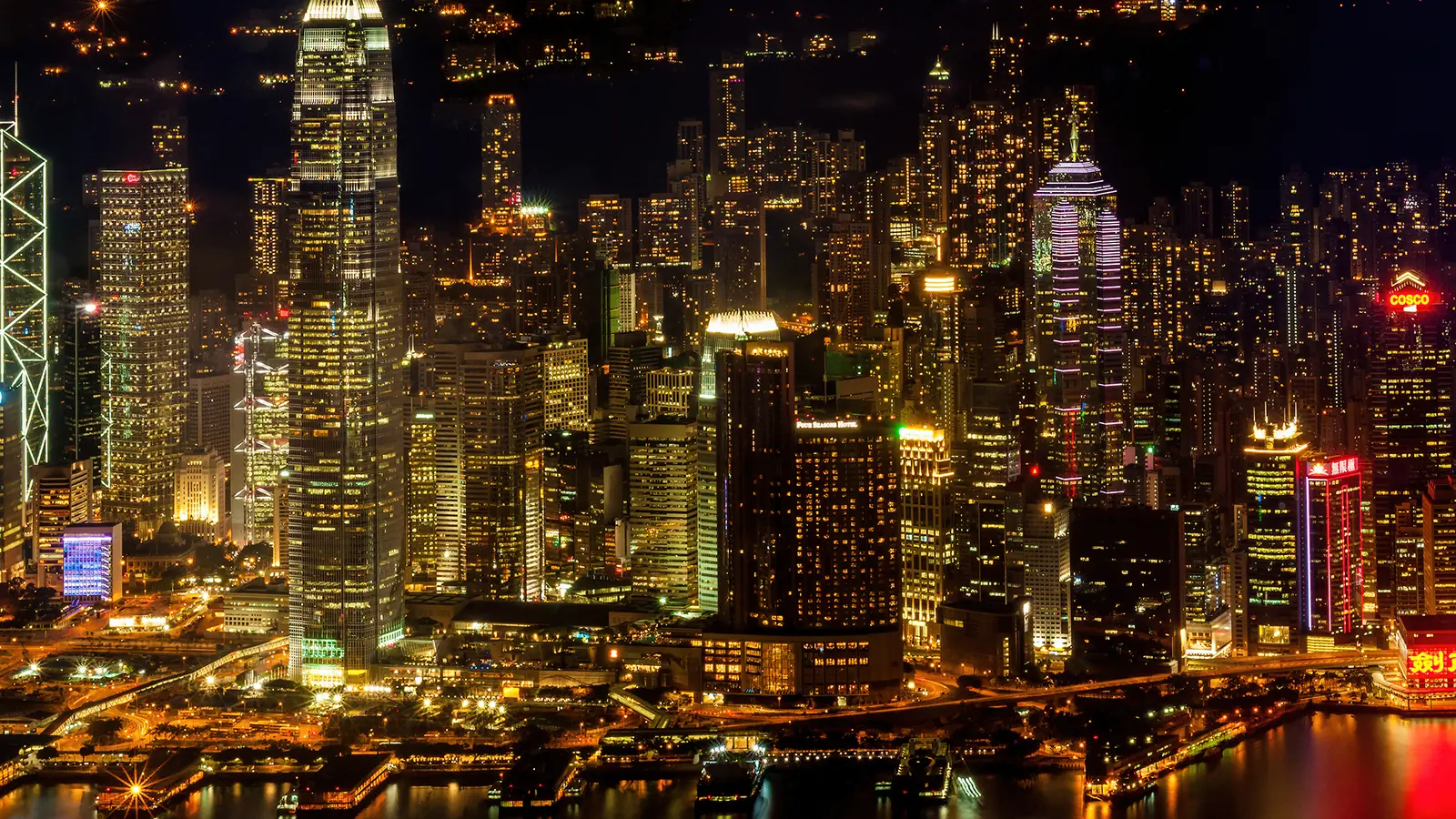 Hong Kong waterfront skyscrapers illuminated against the night sky