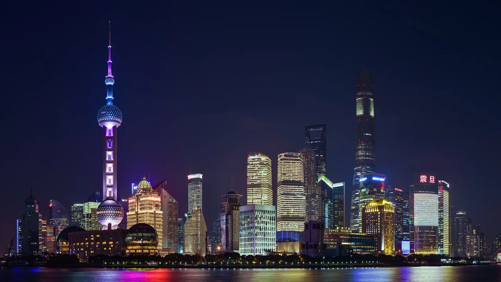 Shanghai waterfront skyline and Oriental Pearl Tower illuminated above the Huangpu River at night