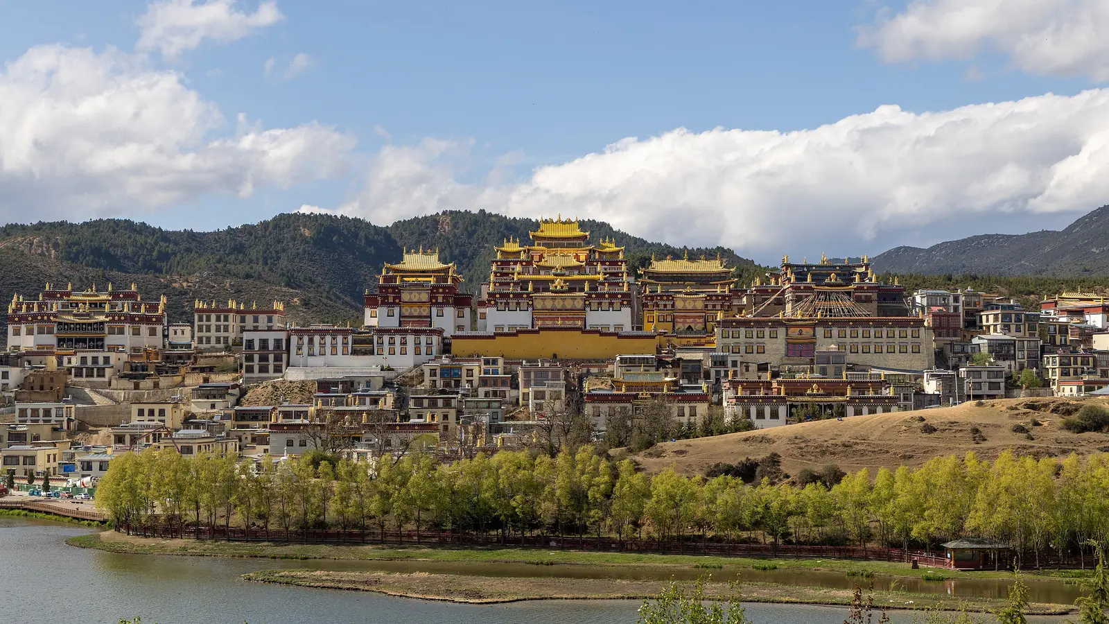Golden roofs of Songzanlin Monastery above clustered buildings in Shangri-La, Yunnan