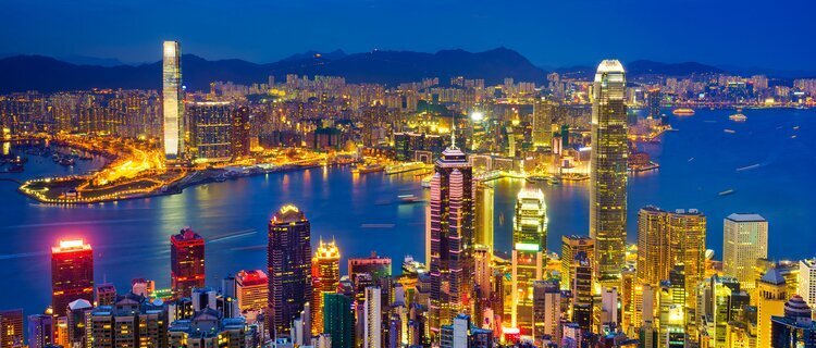 Hong Kong skyline and Victoria Harbour glittering with gold lights at night